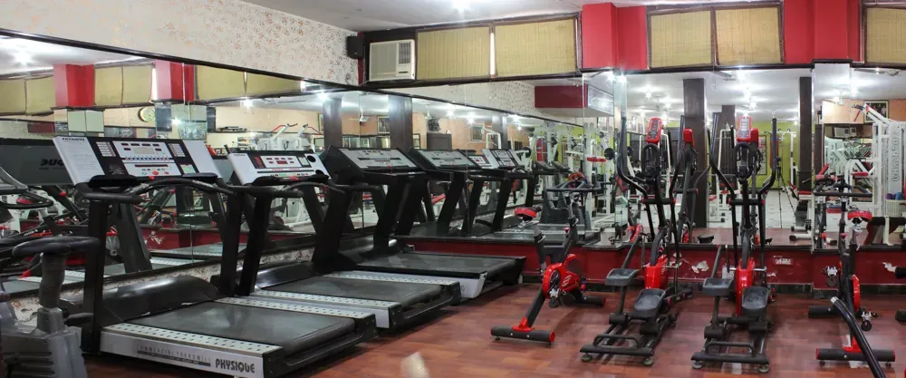 A row of treadmills and cross-trainers in the cardio zone