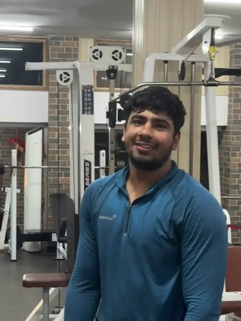 A member at the cable machine station on the gym floor